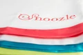 The Snoozle slide sheet logo